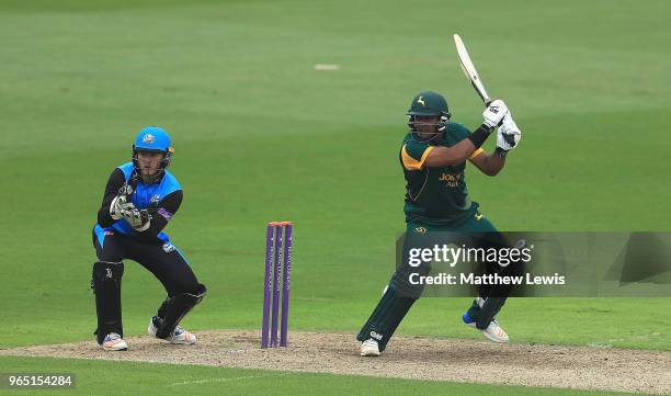 Samit Patel of Nottinghamshire hits the ball towards the boundary, as Ben Cox of Worcestershire looks on during the Royal London One-Day Cup match...