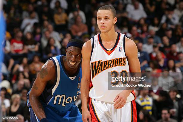 Josh Howard of the Dallas Mavericks and Stephen Curry of the Golden State Warriors wait for the refs to decide a call on February 8, 2010 at Oracle...
