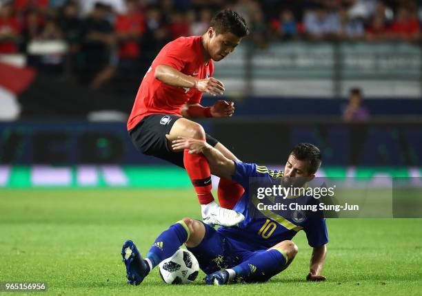 Hwang Hee-Chan of South Korea competes for the ball with Miralem Pjanic of Bosnia & Herzegovina during the international friendly match between South...