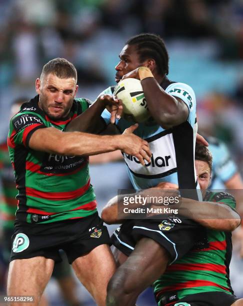 Edrick Lee of the Sharks is tackled by Robbie Farah of the Rabbitohs during the round 13 NRL match between the South Sydney Rabbitohs and the...