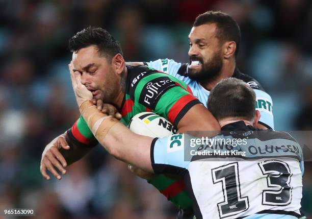 John Sutton of the Rabbitohs is tackled during the round 13 NRL match between the South Sydney Rabbitohs and the Cronulla Sharks at ANZ Stadium on...