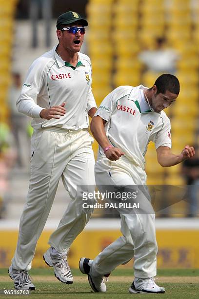 South African cricket captain Graeme Smith celebrates with teammate Wayne Parnell after the dismissal of Indian batsman Subramaniam Badrinath on the...