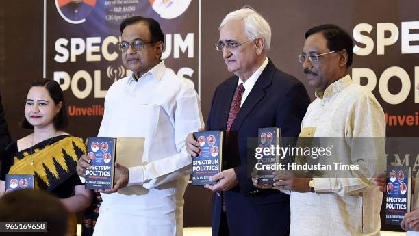 Congress leaders P. Chidambaram, Salman Khurshid, and Pavan K Verma pose for a group photo during the launch of Salman Khurshids book 'Spectrum...