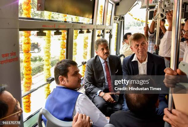 Chief Minister of Maharashtra Devendra Fadnavis along with State Minister of Health Harsh Vardhan and Entrepreneur Anand Mahindra travelling in...