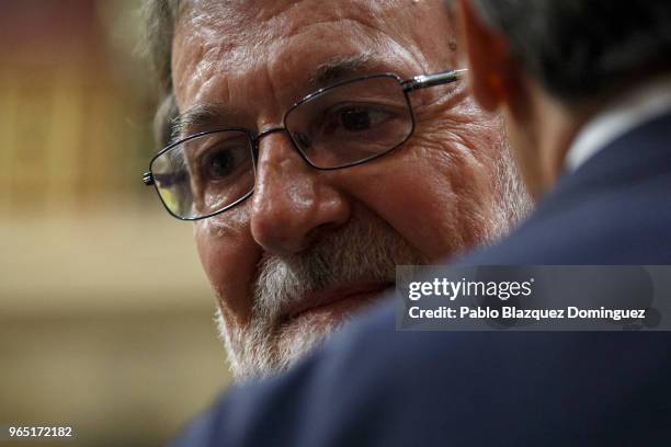 Spanish Prime Minister Mariano Rajoy looks on as a party member supports him before the voting for the no-confidence motion at the Lower House of the...