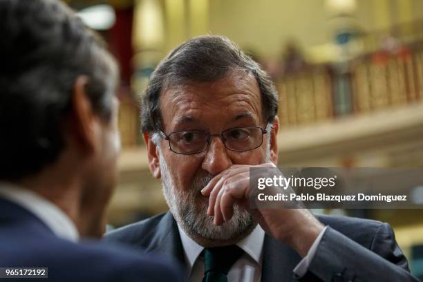 Spanish Prime Minister Mariano Rajoy gestures as a party member talks to him before the voting for the no-confidence motion at the Lower House of the...