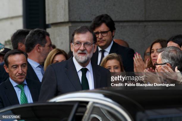 Spanish Prime Minister Mariano Rajoy is applauded by party members as he leaves after losing the no-confidence motion at the Lower House of the...