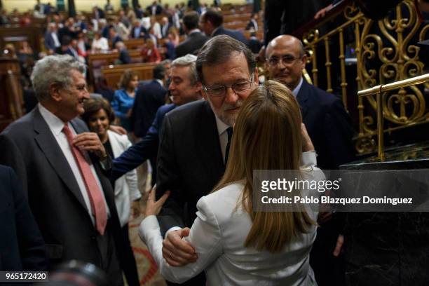 Spanish Prime Minister Mariano Rajoy gets the support of a party member before the voting for the no-confidence motion at the Lower House of the...