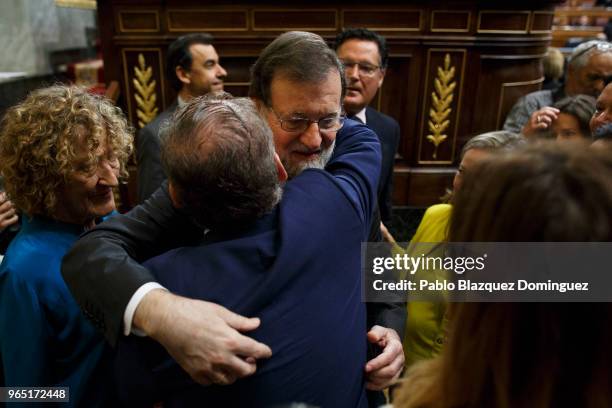 Spanish Prime Minister Mariano Rajoy gets the support of a party member before the voting for the no-confidence motion at the Lower House of the...