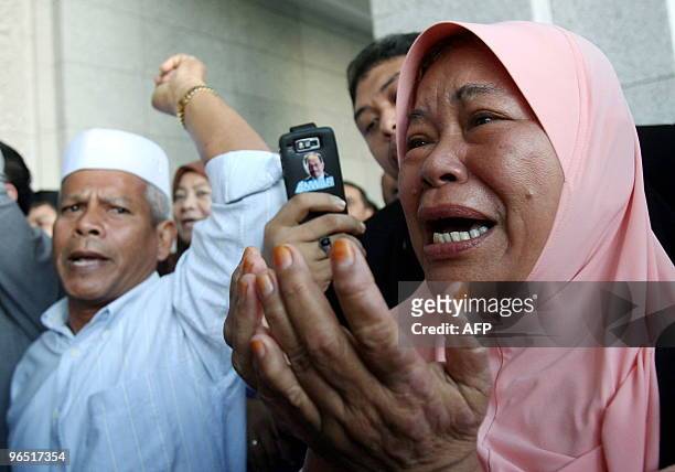 Supporters of former chief minister of Perak Mohammad Nizar Jamaluddin, react during a protest outside the Federal Court in Putrajaya, outside Kuala...