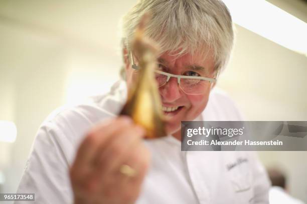 Herbert Hintner, chef at "Zur Rose" restaurant, prepares lamb shoulder in the restaurant kitchen on May 31, 2018 in Eppan, Italy. "Zur Rose," located...