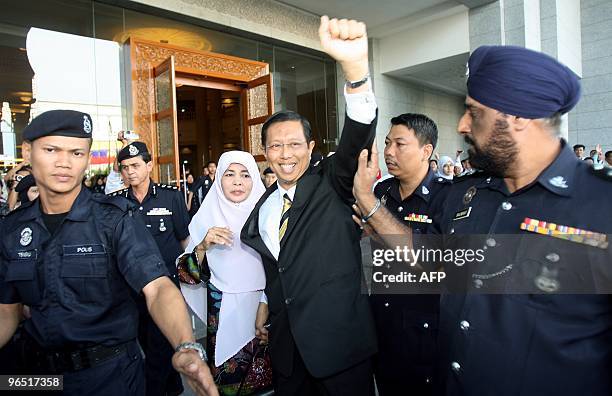 Former chief minister of Perak Mohammad Nizar Jamaluddin and his wife Fatimah Taat wave to their supporters upon arriving at the Federal Court in...