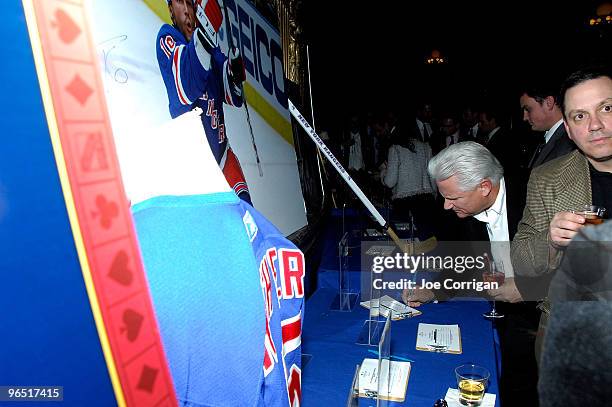 View of the silent auction table as a guest places a bid on an item during casino night to benefit the Garden Of Dreams Foundation at Gotham Hall on...