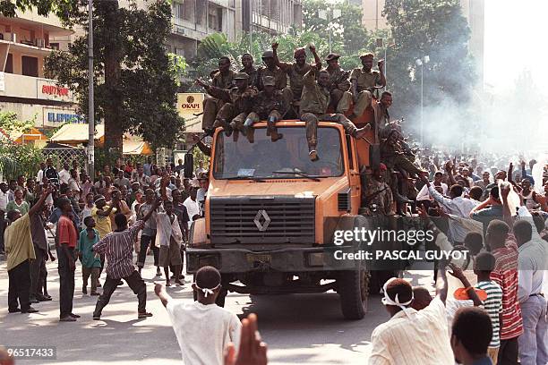 Laurent Desire Kabila's Alliance rebel troops are cheered upon their arrival in central Kinshasa 18 May 1997. Downtown Kinshasa celebrated 18 May...