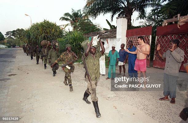 Foreign national and his staff greet Laurent Desire Kabila's Alliance rebel troops entering Kinshasa, 17 May 1997. Downtown Kinshasa celebrated 18...