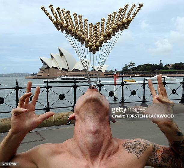 Internationally renowned street performer Chayne Hultgren , re-enacts his 18-sword swallowing attempt for a Guinness World Record in front of the...