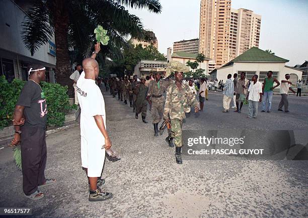 Kinshasa inhabitants greet Laurent Desire Kabila's Alliance rebel troops entering the city, 17 May 1997. Downtown Kinshasa celebrated 18 May 1997 as...