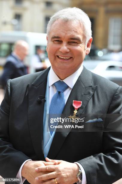 Eamonn Holmes wears his OBE after it was awarded to him by Queen Elizabeth II for services to broadcasting during an Investiture ceremony at...
