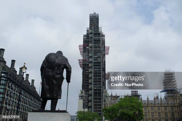 The statue of Sir WInston Churchill stands in Parliament Square, against the backdrop of the Elizabeth Tower, commonly known as Big Ben covered with...