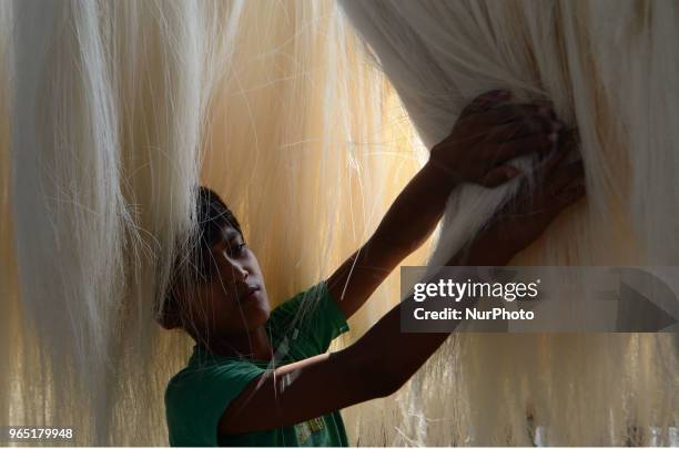 An Indian minor worker dries up vermicelli,a traditional sweet dish ,in a factory , ahead of Eid Al Fitr festival , in the old streets of Allahabad...