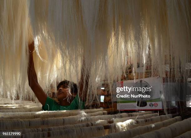 An Indian minor worker dries up vermicelli,a traditional sweet dish ,in a factory , ahead of Eid Al Fitr festival , in the old streets of Allahabad...