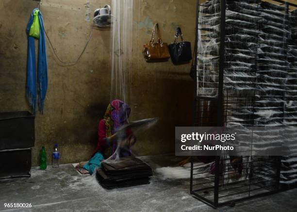 An Indian woman worker prepares vermicelli,a traditional sweet dish ,in a factory , ahead of Eid Al Fitr festival , in the old streets of Allahabad...