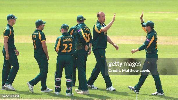 Luke Fletcher of Nottinghamshire is congratulated on the wicket of Joe Clarke of Worcestershire during the Royal London One-Day Cup match between...