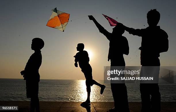 An Indian man flies a kite by the sea in Mumbai on January 14, 2009. Makar Sakranti, the Hindu kite festival, marks the transition of the sun from...