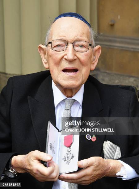 Lieutenant Colonel Mordaunt Cohen holds his medal after he was appointed Member of the Order of the British Empire for services to Second World War...