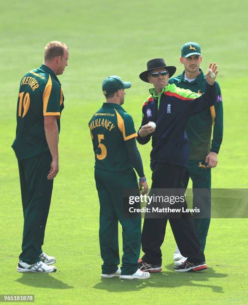 Umpire Nigel Llong looks to change the ball during the Royal London One-Day Cup match between Nottinghamshire nad Worcestershire at Trent Bridge on...