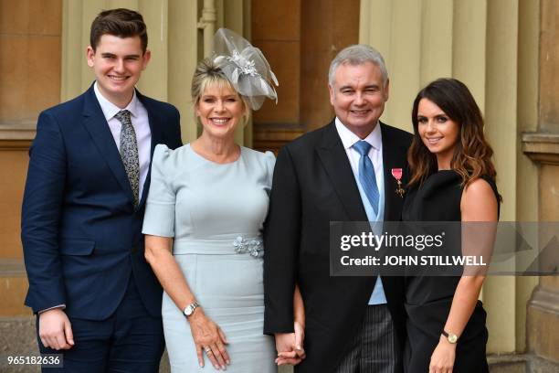 Journalist and broadcaster, Eamonn Holmes, , with his wife Ruth Langsford , his son Jack and daughter Rebecca, poses with his medal after he was...