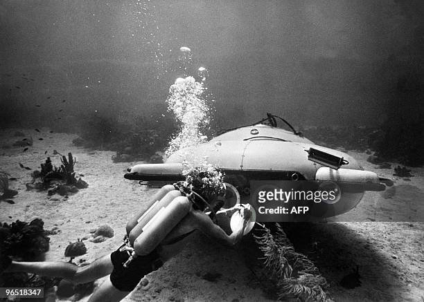 Picture taken in June 1963 of French explorer and oceanographer Jacques-Yves Cousteau near his "diving saucer" during an undersea exploration in the...