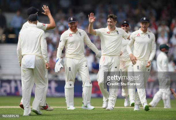 England bowler Chris Woakes celebrates with team mates after catching Hasan Ali off his own bowling during day one of the second Test Match between...