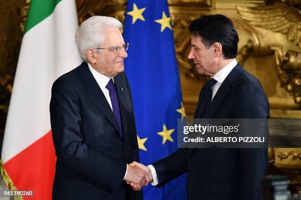 Italys Prime Minister Giuseppe Conte shakes hands with Italy's President Sergio Mattarella during the swearing in ceremony of the new government led...