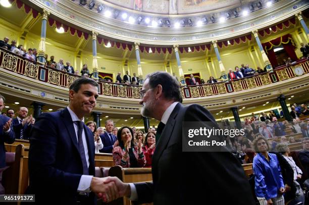 Spanish new Prime Minister Pedro Sanchez shakes hands with former Prime Minister Mariano Rajoy after Sanchez won the no-confidence motion at the...