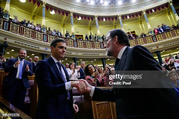 Spanish new Prime Minister Pedro Sanchez shakes hands with former Prime Minister Mariano Rajoy after Sanchez won the no-confidence motion at the...