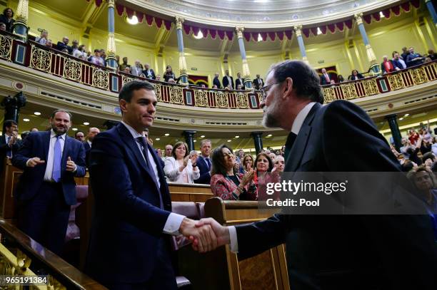 Spanish new Prime Minister Pedro Sanchez shakes hands with former Prime Minister Mariano Rajoy after Sanchez won the no-confidence motion at the...