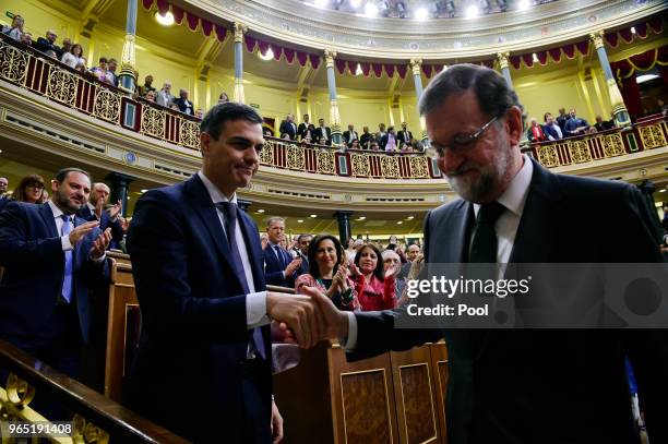 Spanish new Prime Minister Pedro Sanchez shakes hands with former Prime Minister Mariano Rajoy after Sanchez won the no-confidence motion at the...