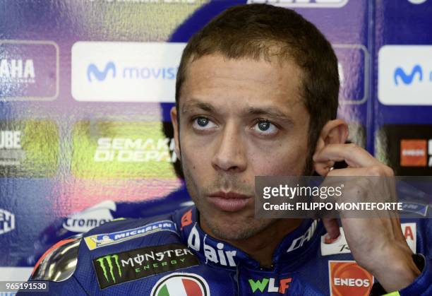 Movistar Yamaha Italian rider Valentino Rossi watches a practice session in the box during a free practice session ahead of the Italian MotoGP Grand...