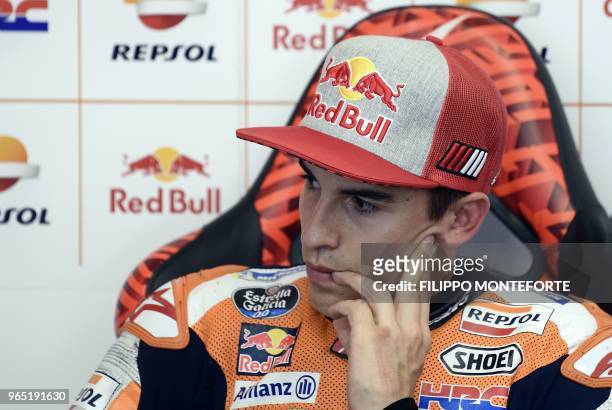 Repsol Honda Team's Spanish rider Marc Marquez watches a practice session in the box during a free practice session ahead of the Italian MotoGP Grand...