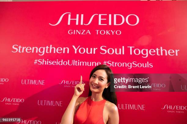 Taew, a Shiseido brand ambassador, poses with the Shiseido logo at the Shiseido Bangkok #Ultimune Launch Event on June 1, 2018 in Bangkok, Thailand....