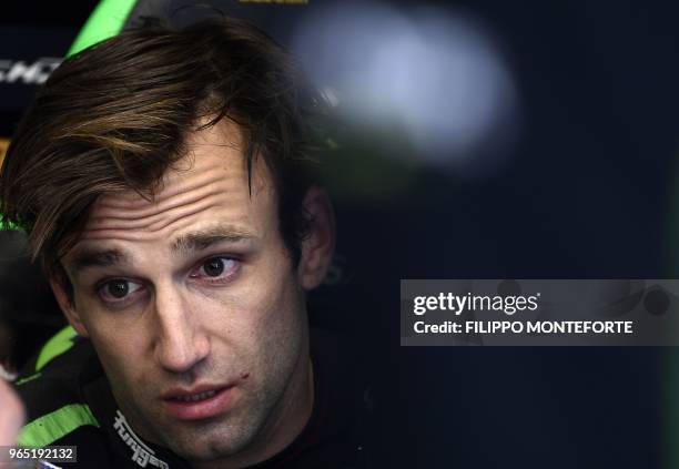 Monster Yamaha Tech 3's French rider Johann Zarco looks on as he sits in the box during a free practice session ahead of the Italian MotoGP Grand...