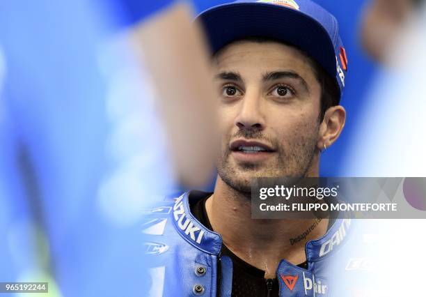 Team Suzuki Ecstar's Italian rider Andrea Iannone looks on in the box during a free practice session ahead of the Italian MotoGP Grand Prix at the...