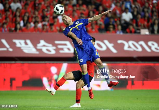 Eldar Civic of Bosnia & Herzegovina competes for the ball with Moon Seon-Min of South Korea during the international friendly match between South...