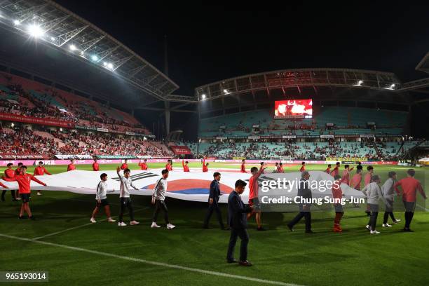 South Korean team players hold a national flag during a sending off ceremony for FIFA World Cup Russia 2018 after the international friendly match...