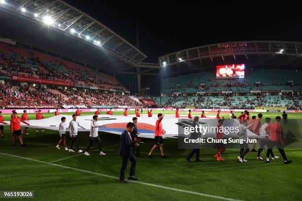 South Korean team players hold a national flag during a sending off ceremony for FIFA World Cup Russia 2018 after the international friendly match...