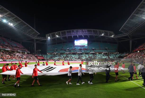 South Korean team players hold a national flag during a sending off ceremony for FIFA World Cup Russia 2018 after the international friendly match...