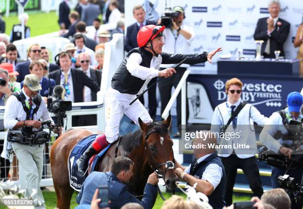 Frankie Dettori riding Cracksman celebrates winning the Investec Coronation Cup during Ladies Day of the Investec Derby Festival at Epsom Downs on...