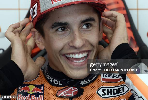 Repsol Honda Team's Spanish rider Marc Marquez smiles as he sits in the box during a free practice session ahead of the Italian MotoGP Grand Prix at...