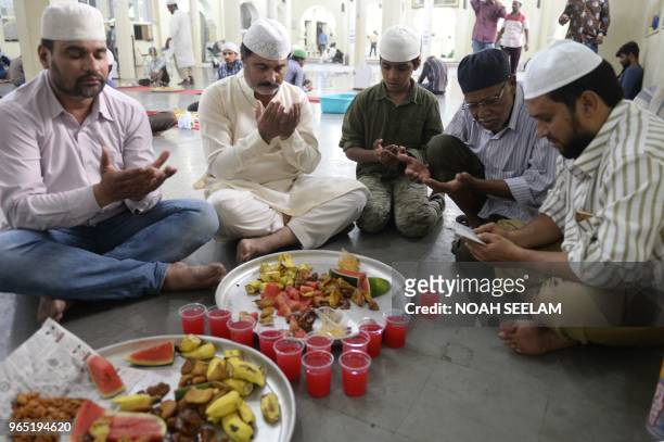 Indian Muslim devotees offer prayers before breaking their fast oduring the Holy month of Ramadan at the Jama Masjid in Secunderabad, the twin city...